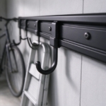 Sliding steel hook on the black rail track in close-up