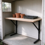 Folding workbench used for potting plants in a garden shed