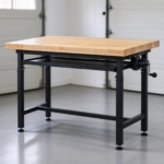 Adjustable-height workbench with maple butcher-block top in a garage