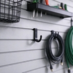 Black steel J-hook locked into a gray slatwall groove